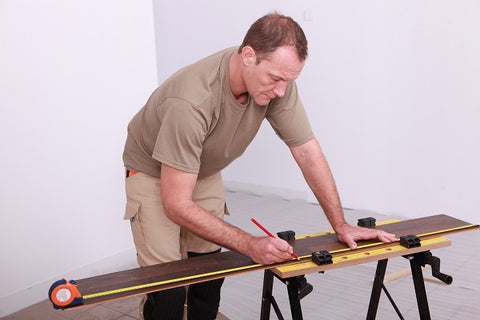 Photo of a man working on a workbench 