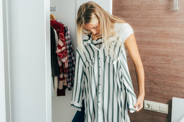 A woman chooses what to wear in her wardrobe tries