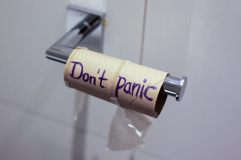 06_A toilet paper’s cardboard tube with the writing, Don’t Panic