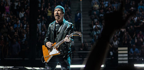 The Edge on stage with a Gibson Explorer