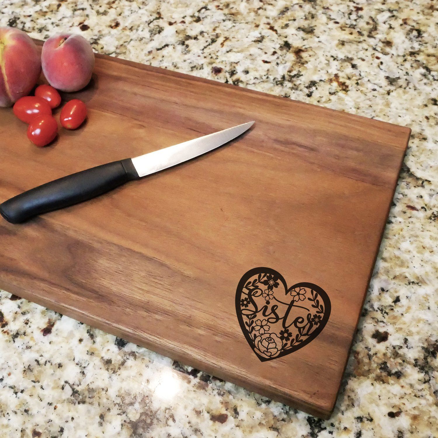 https://cdn.shopify.com/s/files/1/0147/5490/6198/products/sister-floral-heart-engraved-walnut-cutting-board-11-x-16-281892.jpg?v=1628780782