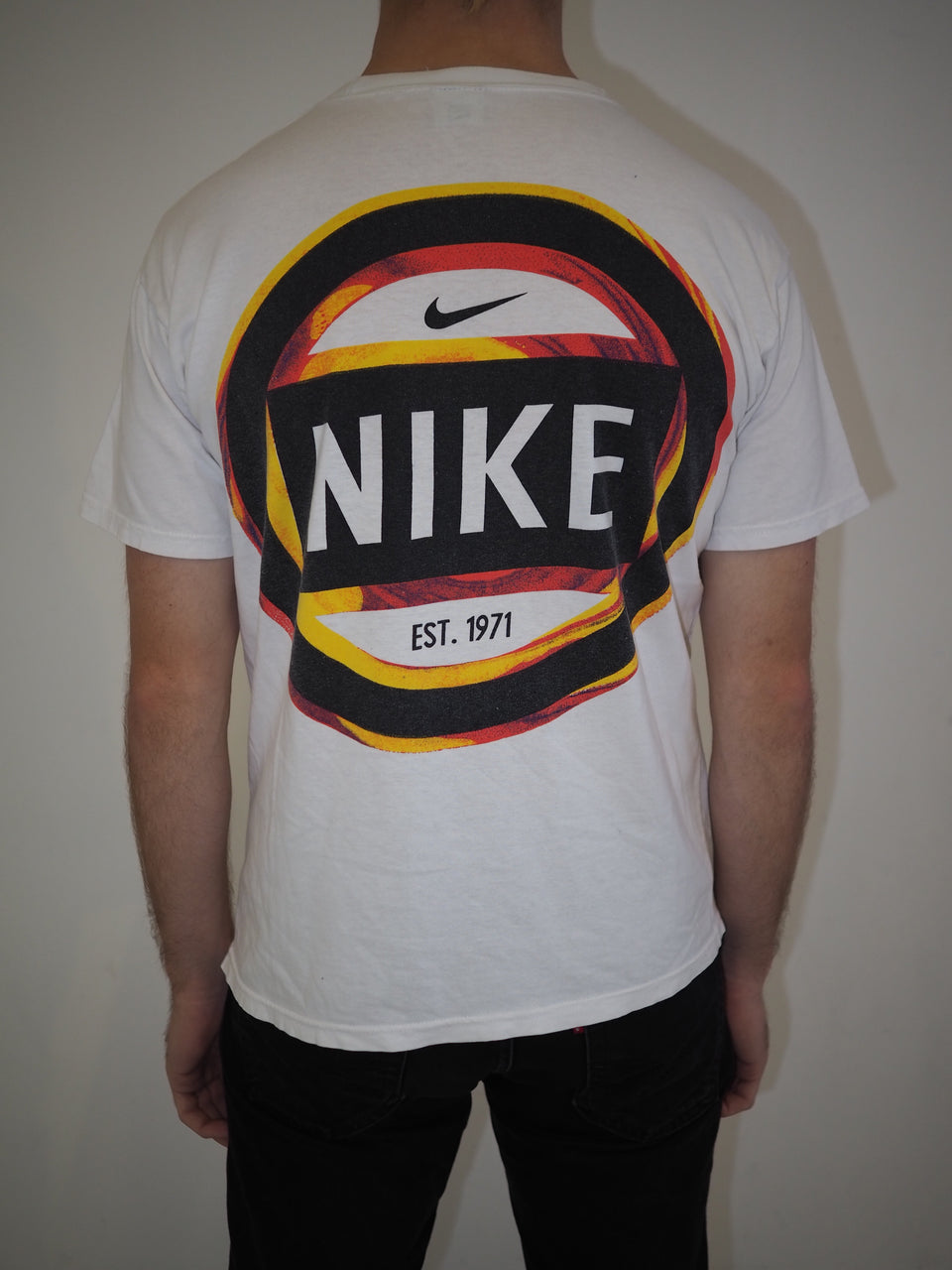 black red and yellow nike shirt