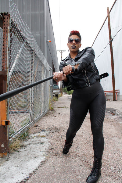 girl swinging a bat wearing rebel boots