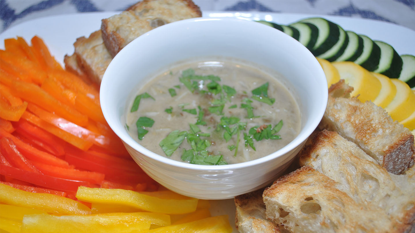 Bagna cauda dip served with cut vegetables and bread slices