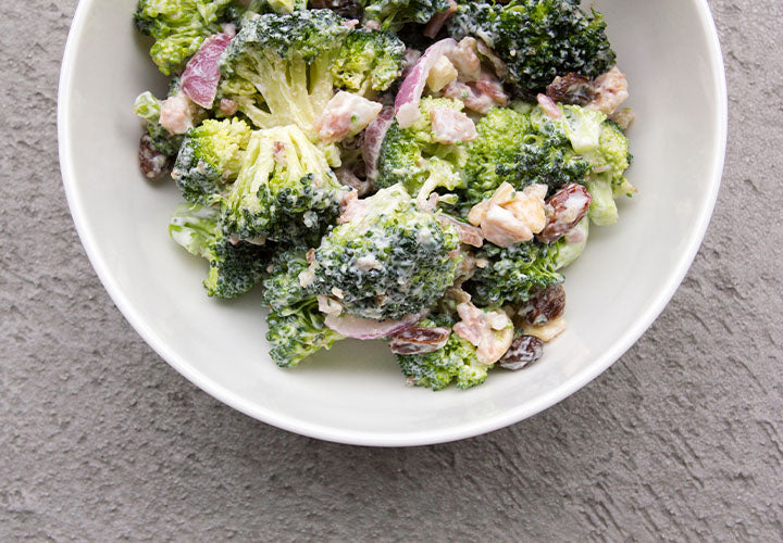 Crunchy broccoli salad with onions, raisins, and nuts.