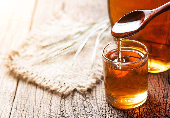 Homemade simple syrup for lattes and tea infused with cloves and cinnamon spices.