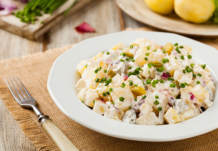 Potato salad seasoned with poppy seeds and Romano cheese spice blend.