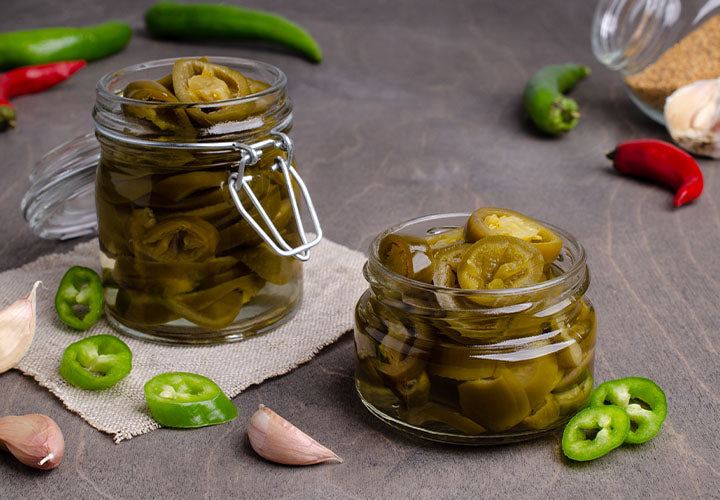 Homemade pickled jalapenos in a jar.