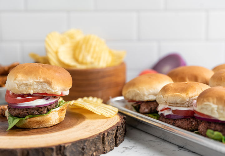 Beef hamburgers with tomato, onion, lettuce and garlic mayo.