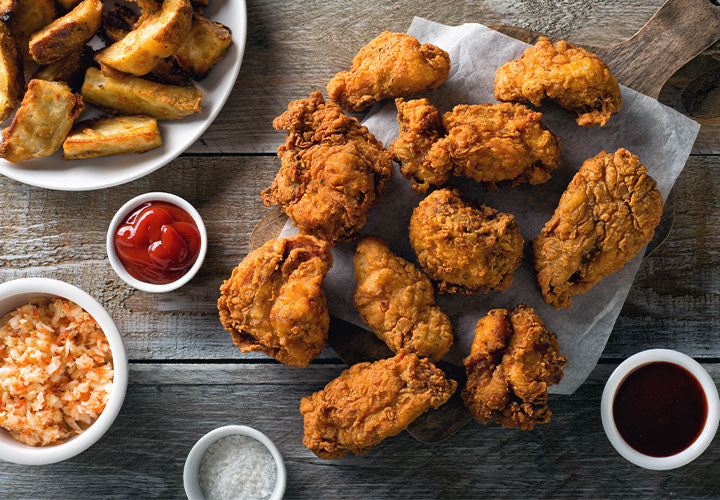 Fried chicken served with ketchup and coleslaw.