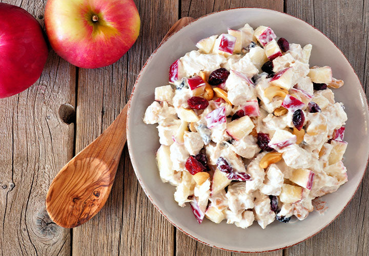Potato salad with apples, nuts, and dried cranberries.