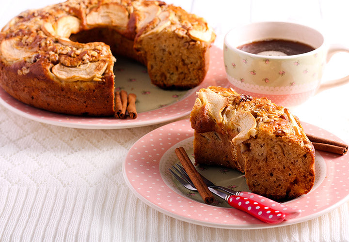 Apple cake made with sweet baking spices baked in a round bundt pan.