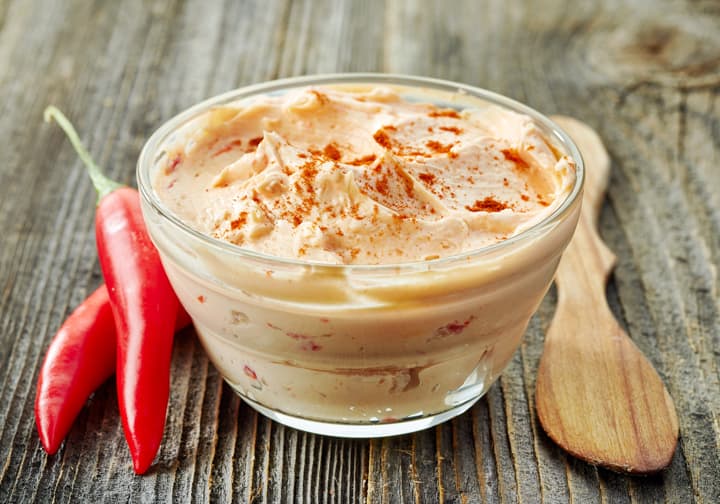 Spicy cream cheese dip with spices and chile peppers.