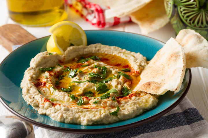 baba ghanoush in a bowl with pita bread chips