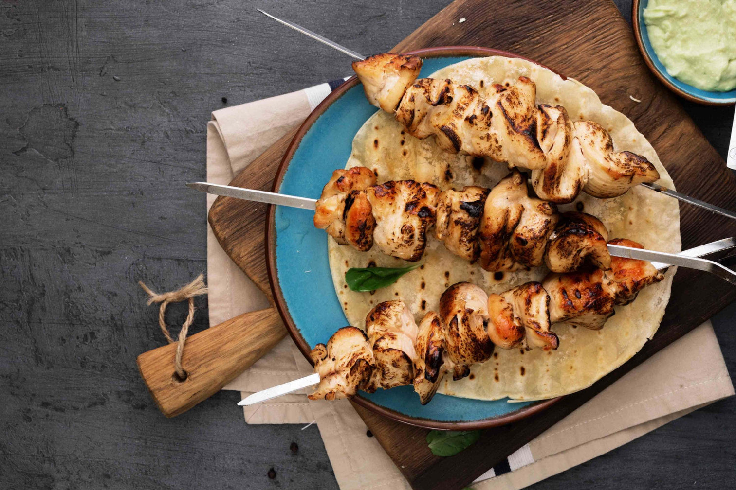 Grilled chicken skewers with piquant spices served on flatbread