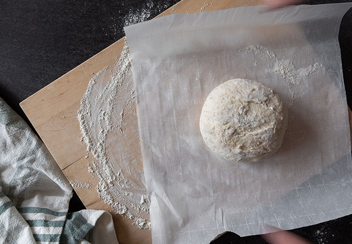 Letting dough sit and rise on floured surface
