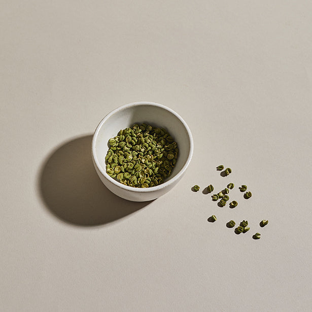 Sansho peppercorns in a small bowl.