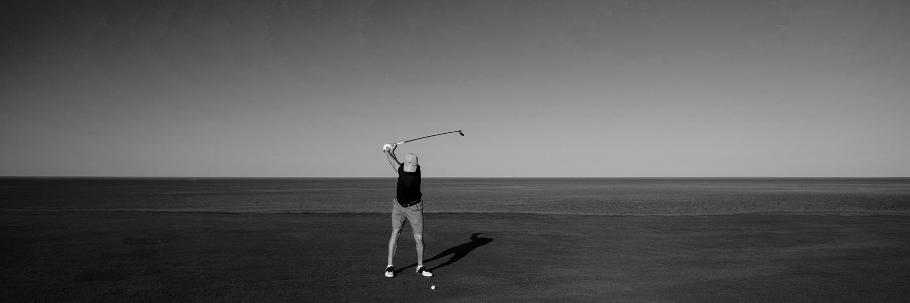 man swinging a golf club 