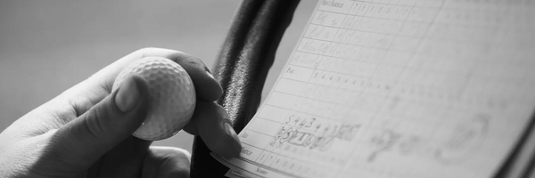 golfer using a scorecard