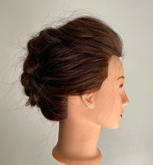 Braided updo on mannequin head profile view