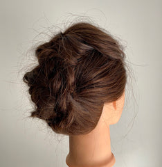 Braided updo on mannequin head side view