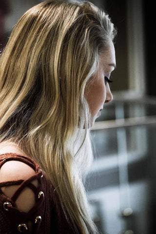 blonde girl with long hair looking away