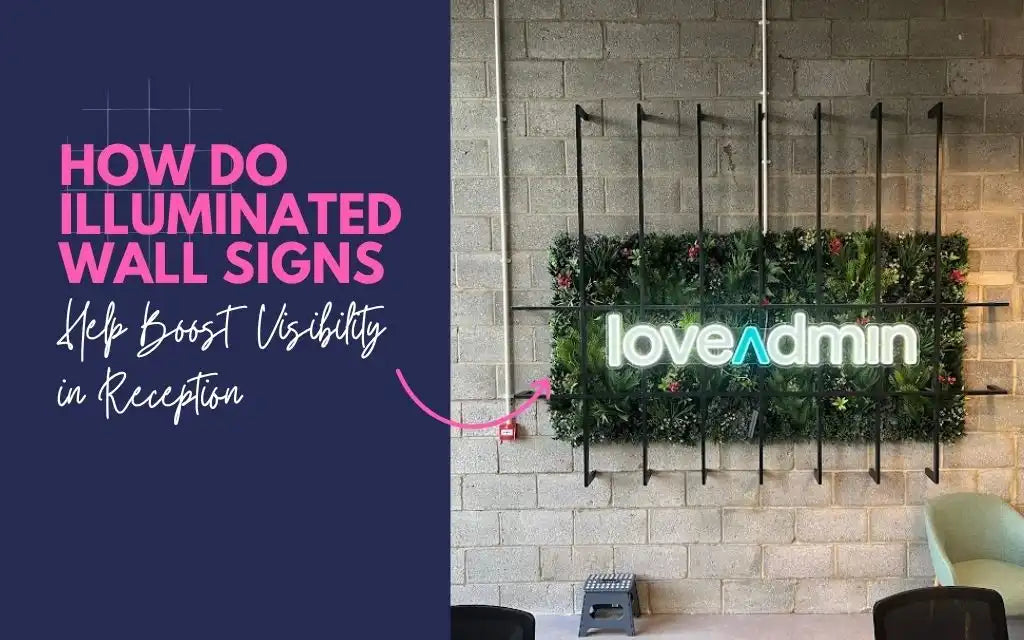 Illuminated wall sign reading “love admin” in a modern reception with plant backdrop