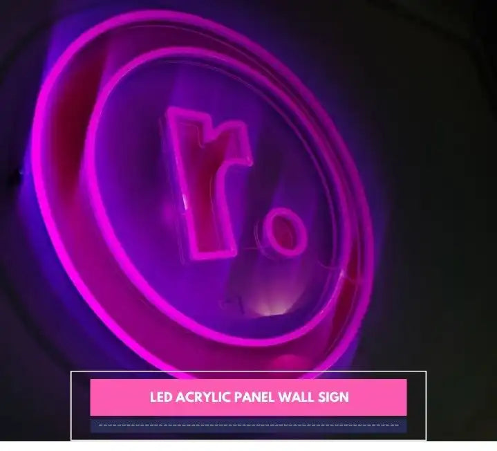 Glowing pink LED acrylic panel wall sign with a bold lowercase “r” and dot