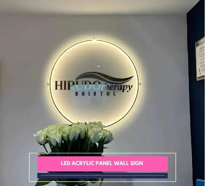LED acrylic panel wall sign glowing behind a floral arrangement in a clinic lobby