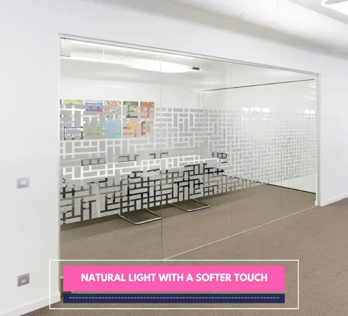 Office space with glass walls featuring geometric frosted patterns for light and privacy.