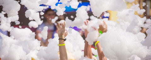 foam party with hands extending out from foam