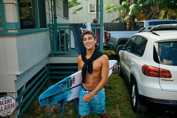 Blenders Entourage athlete Koa Rothman with his surfboard