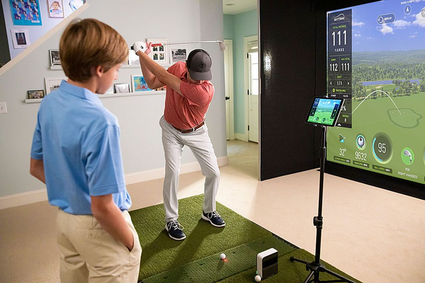 guy practicing on SkyTrak golf simulator