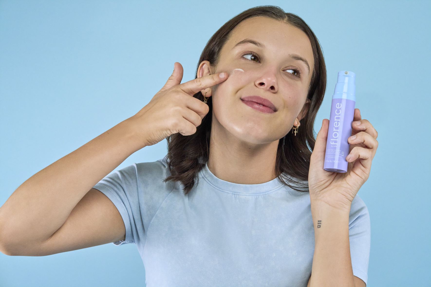 Millie bobby brown putting on facial moisturizer