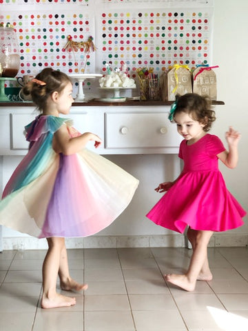 girls in twirling dresses at birthday party for four year olds