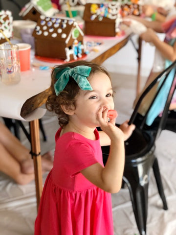 little girl eating candy at birthday party