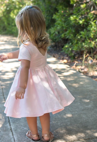 young blonde girl in pink dress