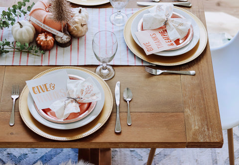 beautiful thanksgiving table with paper plates and chargers