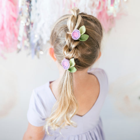 blonde little girl in lavender twirl dress and felt flower bows