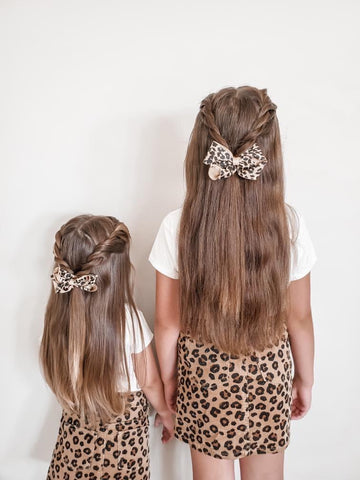 twi girls with braided hairstyles and cute leopard print bows ollie jay dresses