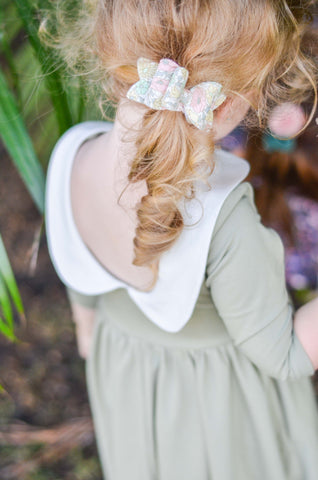 Close up of back of a green twirly dress with peter pan collar