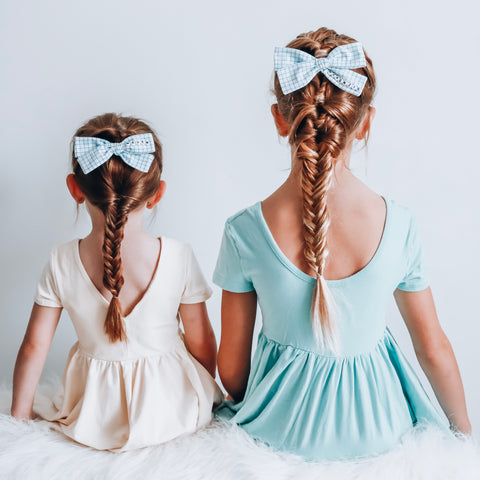 Two Girls with braid and hair bow wearing Ollie Jay Twirl Dress