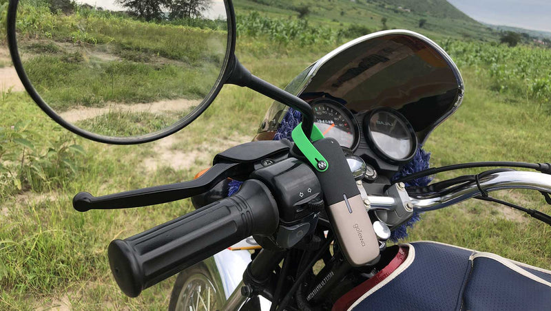 Rafael Muvunga attaches the goTenna Mesh to his motorcycle to enable off grid communication with his colleague