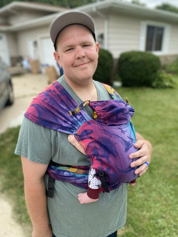 Customer photo of dad carrying newborn in Jurassic Park - New Era Hybrid carrier