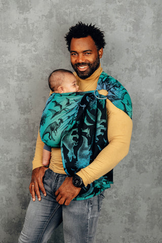 Dad wearing newborn in a Jurassic Park ring sling