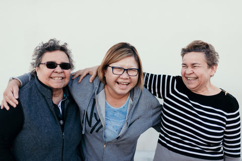 3 mature women embracing 