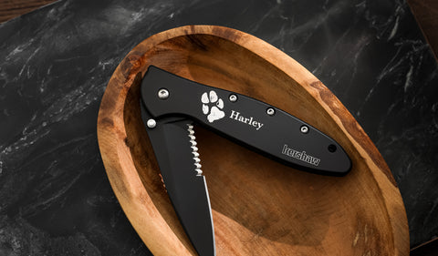 black kershaw pocket knife with paw print