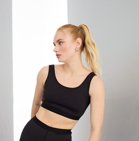 Woman wearing ellina black sportswear with a top