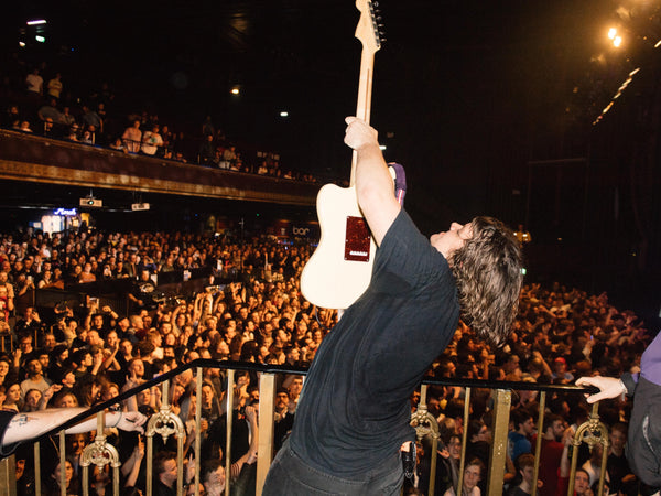 Pricey showcasing his guitar at the Triffid in Brisbane