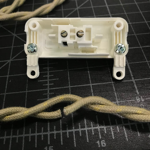 open vintage slim switch and twisted pair wire with cut hot wire